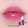 Modelo usando Tocobo Juicy Berry Plumping Lip Oil tono Berry Brandy 02 en los labios.