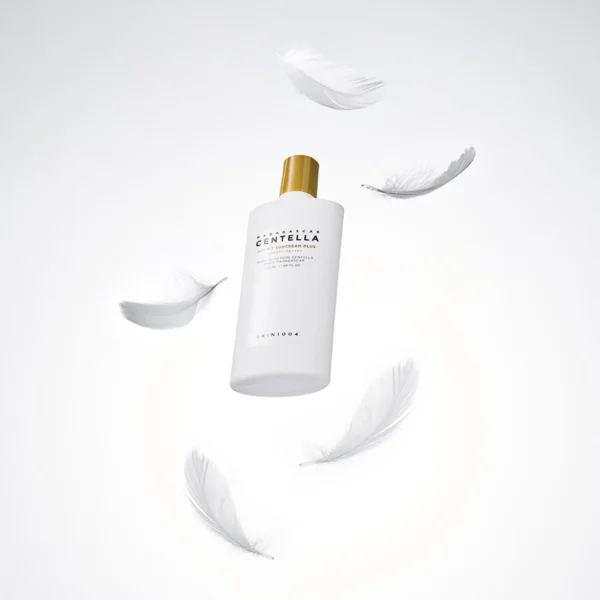 Protector solar Madagascar Centella Air-Fit Suncream Light de SKIN1004 acompañado de plumas blancas en composición artística